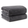 Two folded grey microfiber bath towels stacked on a white background.