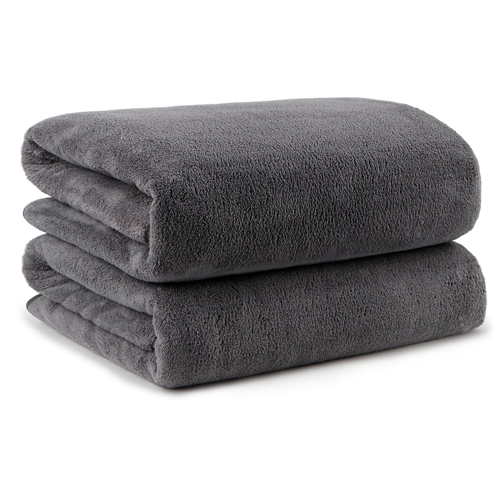 Two folded grey microfiber bath towels stacked on a white background.