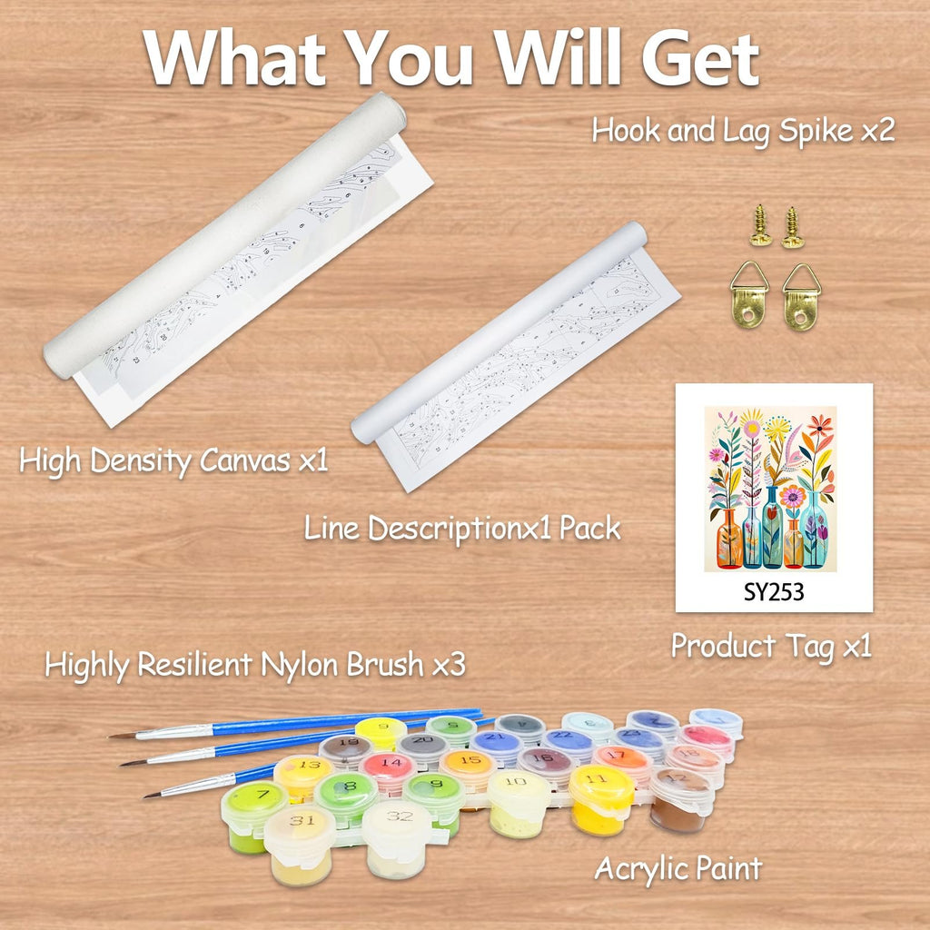 Paint by numbers kit contents laid out on a wooden surface, showing rolled canvas, brushes, acrylic paints, and hardware.