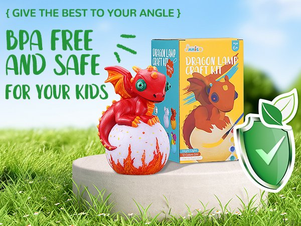 Paint-your-own dragon lamp craft kit with painted dragon and box, set on a pedestal with grass background.