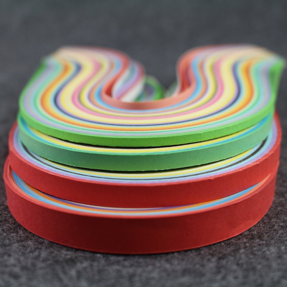Stack of colorful paper quilling strips in red, green, yellow, blue, and pastel shades, arranged in a U-shape on a dark textured surface.