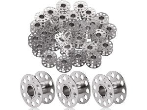 Plastic sewing machine bobbins, 50 pack, shown in a pile and three individual bobbins in front.