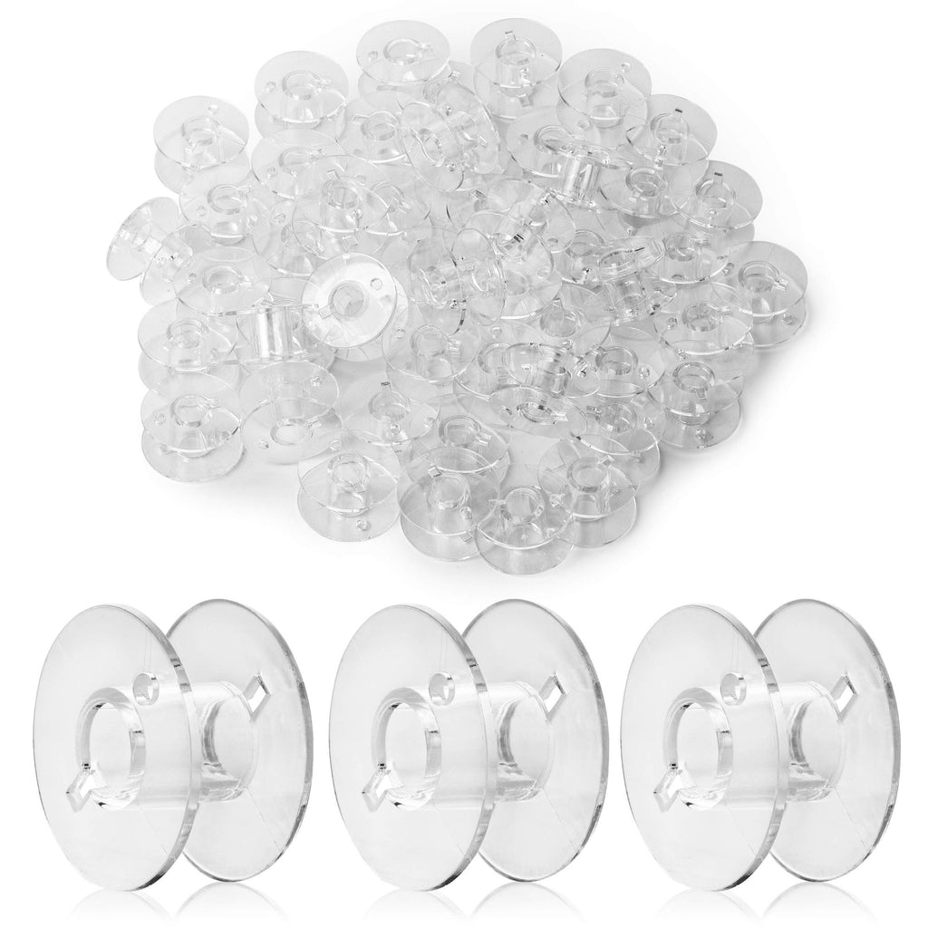 Pile of clear plastic sewing machine bobbins with three bobbins shown individually in the foreground on a white background.