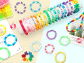 Assortment of colorful beaded bracelets and necklaces, some with letter beads spelling words like 'LOVE', 'ORANGE', 'DIY', 'BLUE', 'FRIEND', and 'FAITH'.