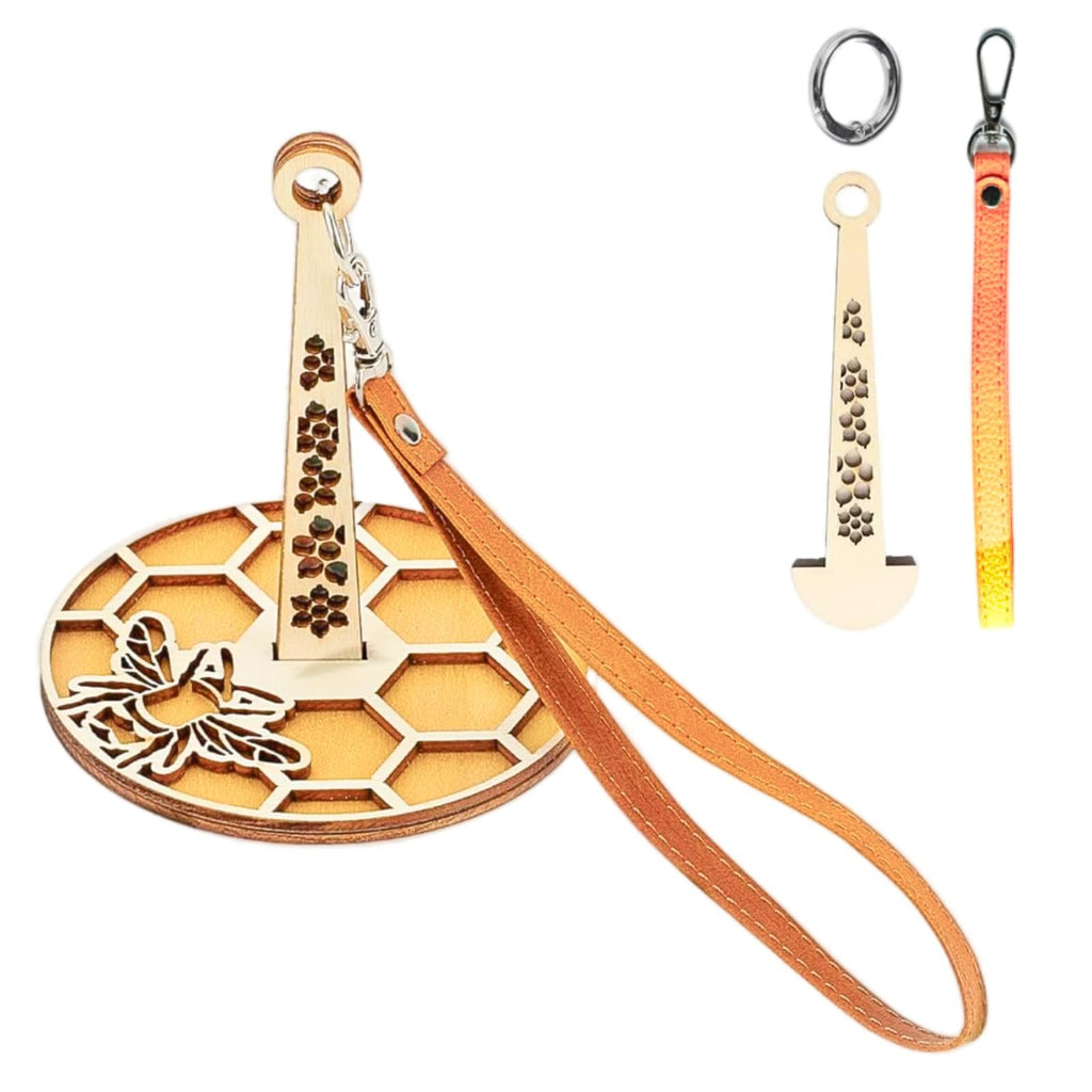Wooden yarn holder with bee and honeycomb design, includes leather strap and extra components.