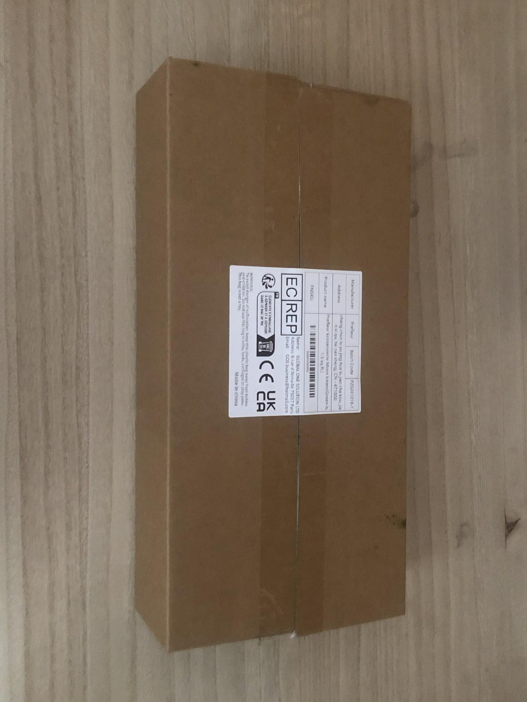 Cardboard box with shipping labels and regulatory markings, showing product details and warnings.