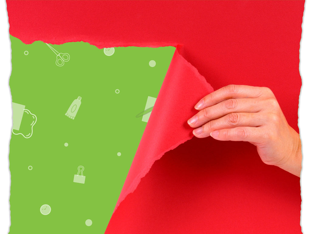 Hand peeling back red paper to reveal green background with craft icons