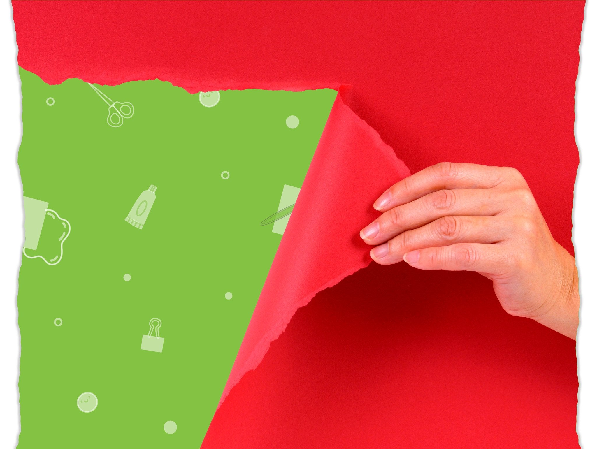 Hand peeling back red paper to reveal green background with craft icons