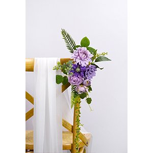Purple artificial flower arrangement with greenery attached to a wooden chair with white fabric draped.