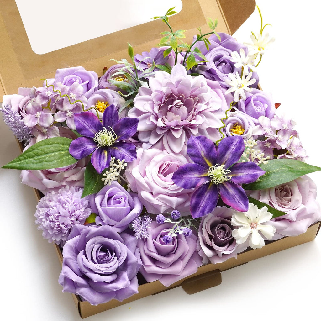 Box of assorted purple artificial flowers including roses, dahlias, and clematis, arranged for display.