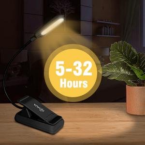 Black clip-on book light with flexible neck and LED illuminating a desk surface, with a yellow circle graphic indicating battery life.