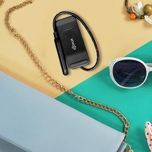 Black rechargeable clip-on book light with branding, shown with accessories on a colorful background.