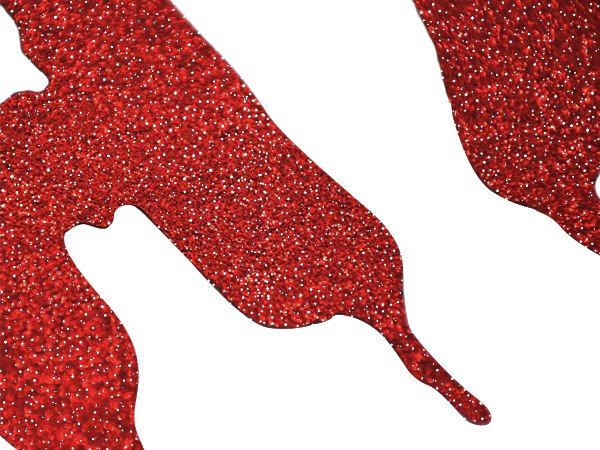 Close-up of red glitter paper bat shapes on a white background, part of a Halloween banner.