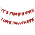Red glitter paper banner with dripping letters spelling "It's Frickin Bats I Love Halloween" on white background