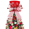 Red velvet candy cane Christmas tree topper hat with bow and ornaments on a decorated tree