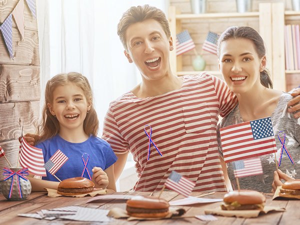 Family celebrating Independence Day with burgers and American flags, with patriotic decorations in the background.