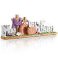 Easter figurine depicting the words 'He is Risen' with crosses, a tomb, and a dove, on a grassy base with flowers.