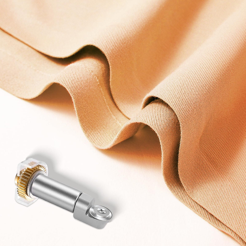 Rotary blade and drive housing next to folded tan fabric on a white background