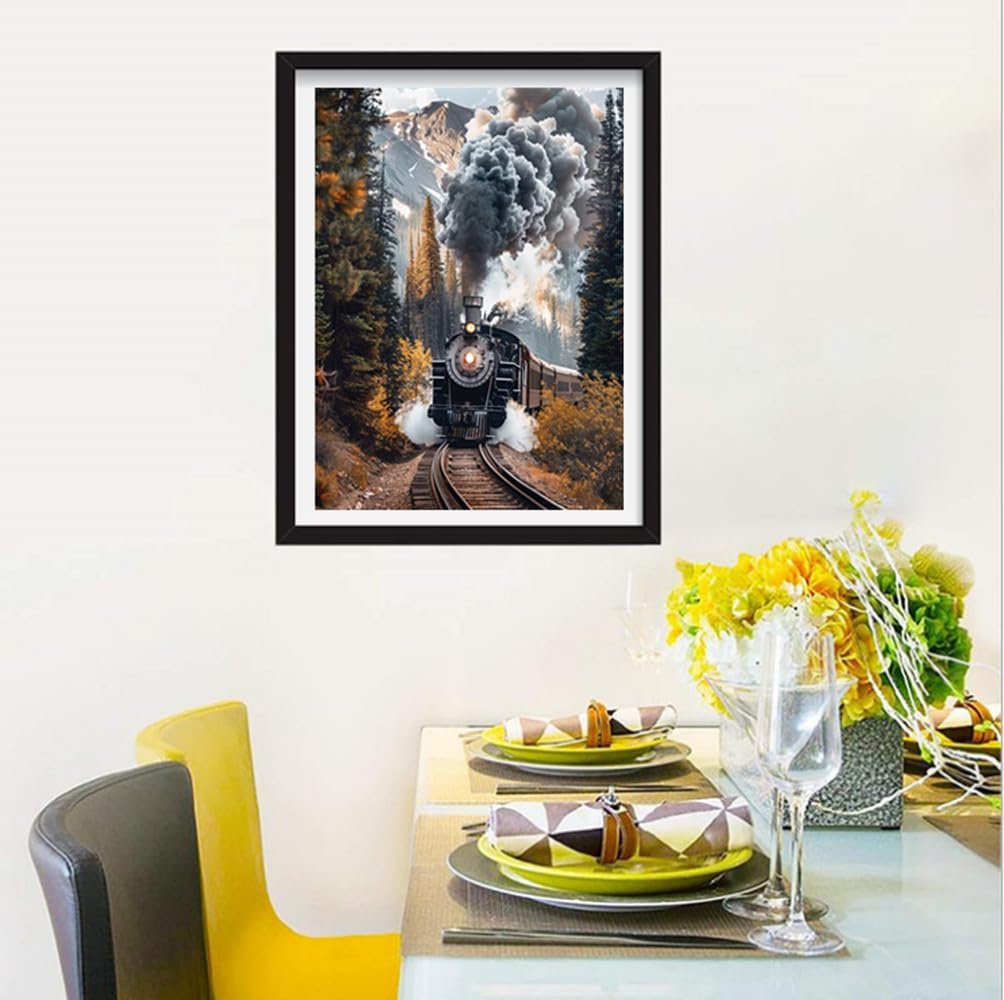 Framed diamond painting of a steam train traveling through a forest with mountains in the background.