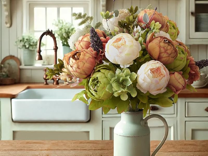 Artificial peony bouquet in a vase on a wooden table in a kitchen setting