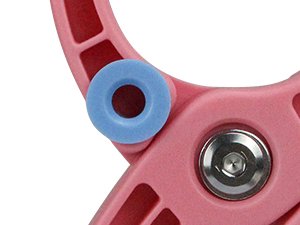 Close-up of a pink crochet safety eye tool with a blue washer and metal screw on a white background.
