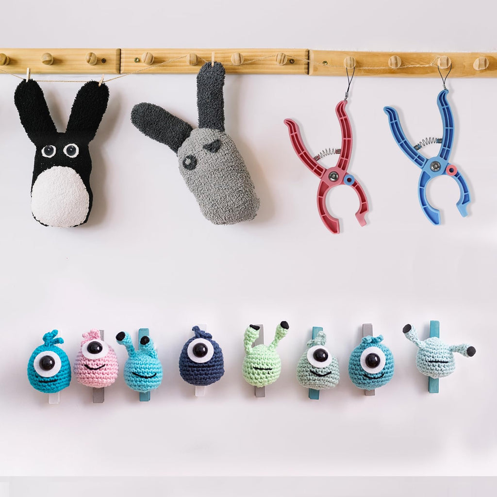 Crocheted monster eyes and bunny crafts hanging on a wooden rack with colorful plastic clips