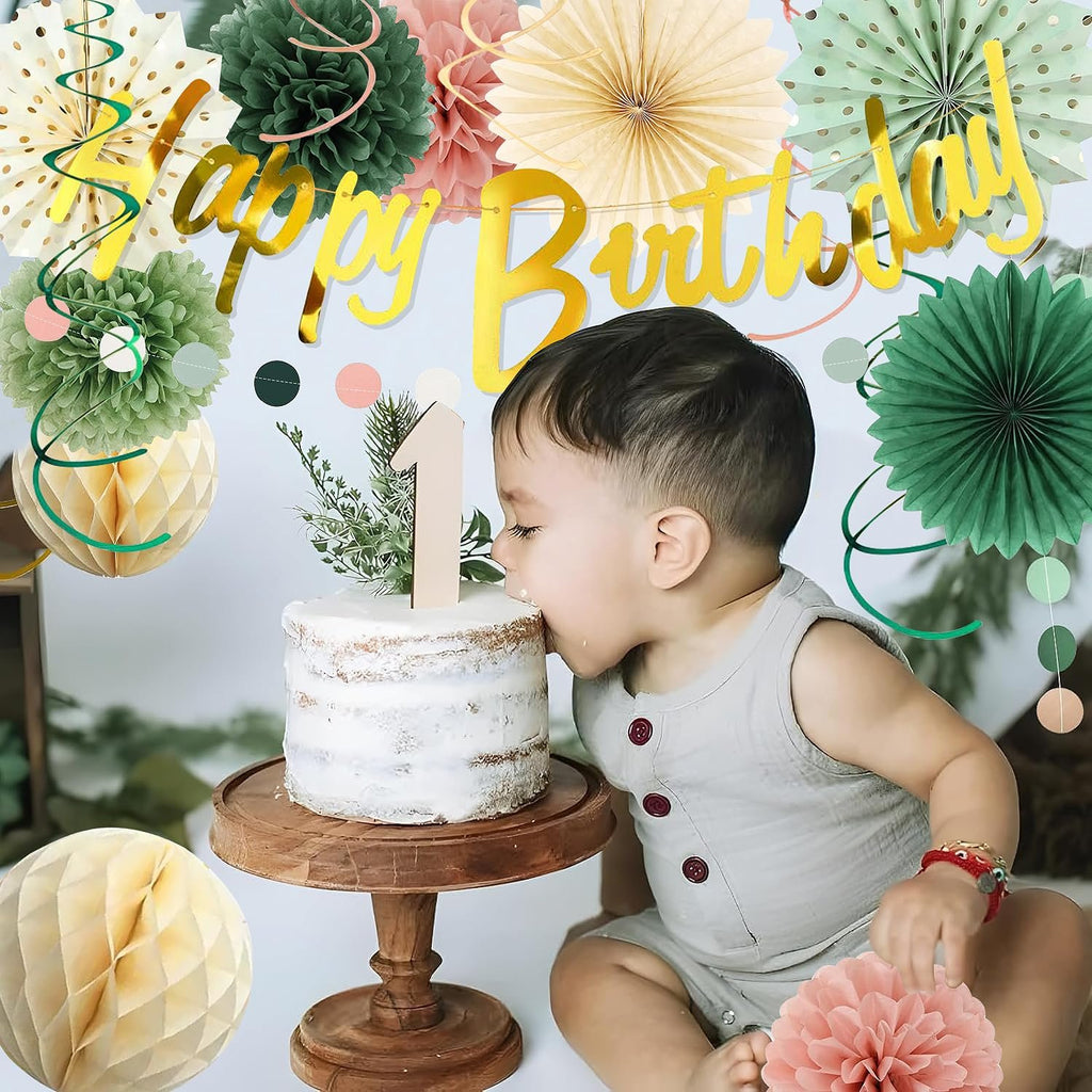Baby boy eating a cake with a '1' candle, surrounded by sage green and pink gold birthday decorations.