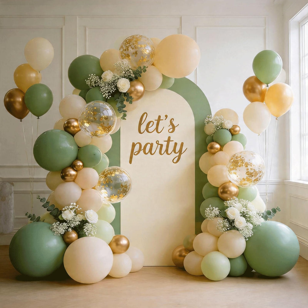 Sage green, cream, and gold balloon arch with confetti balloons and white flowers, featuring 'let's party' text on a cream arch.