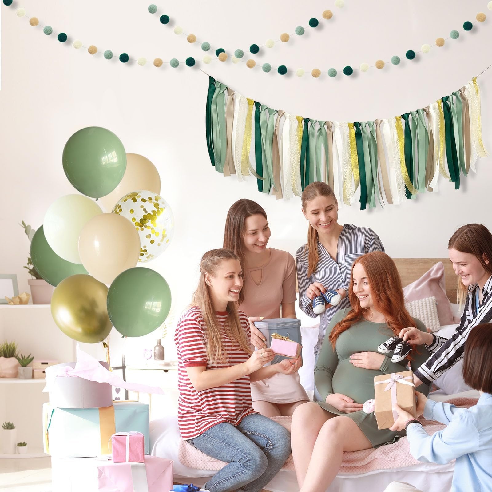 Pregnant woman opening gifts surrounded by friends, with balloons and garlands in the background.