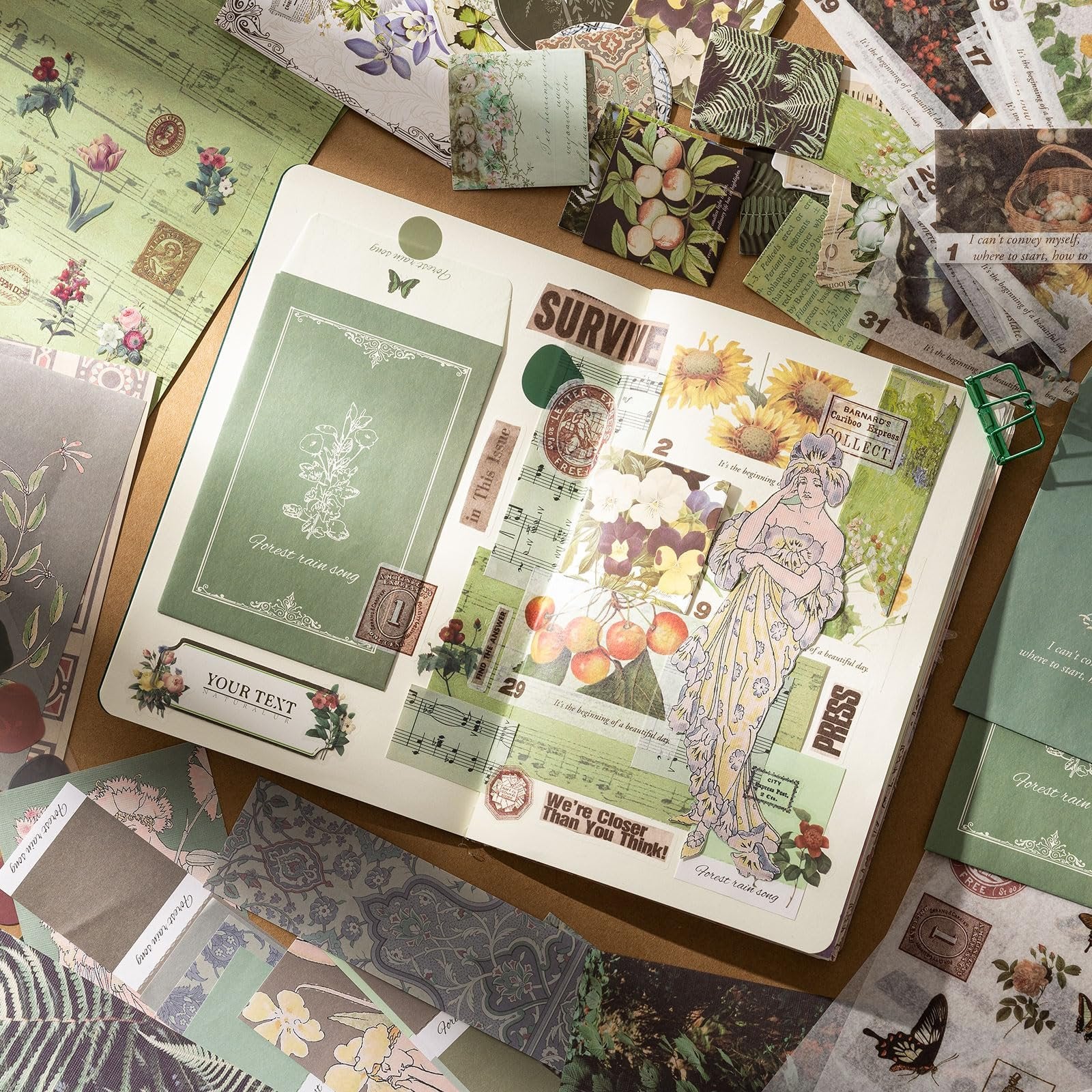 Junk journal and scrapbook supplies laid out on a surface, featuring decorative papers, stickers, and washi tape with floral and vintage motifs.