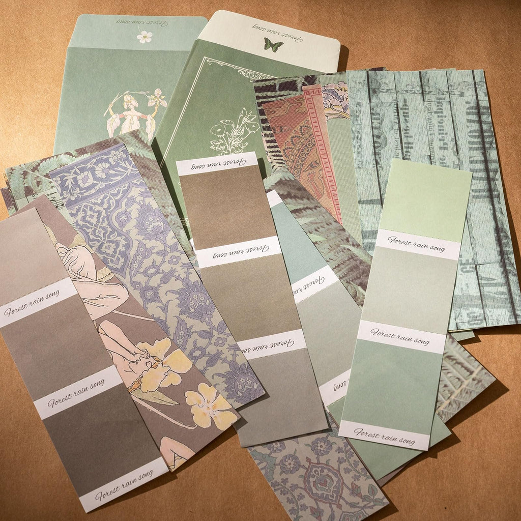 Scrapbook paper and envelopes with floral and vintage patterns, arranged in a flat lay.
