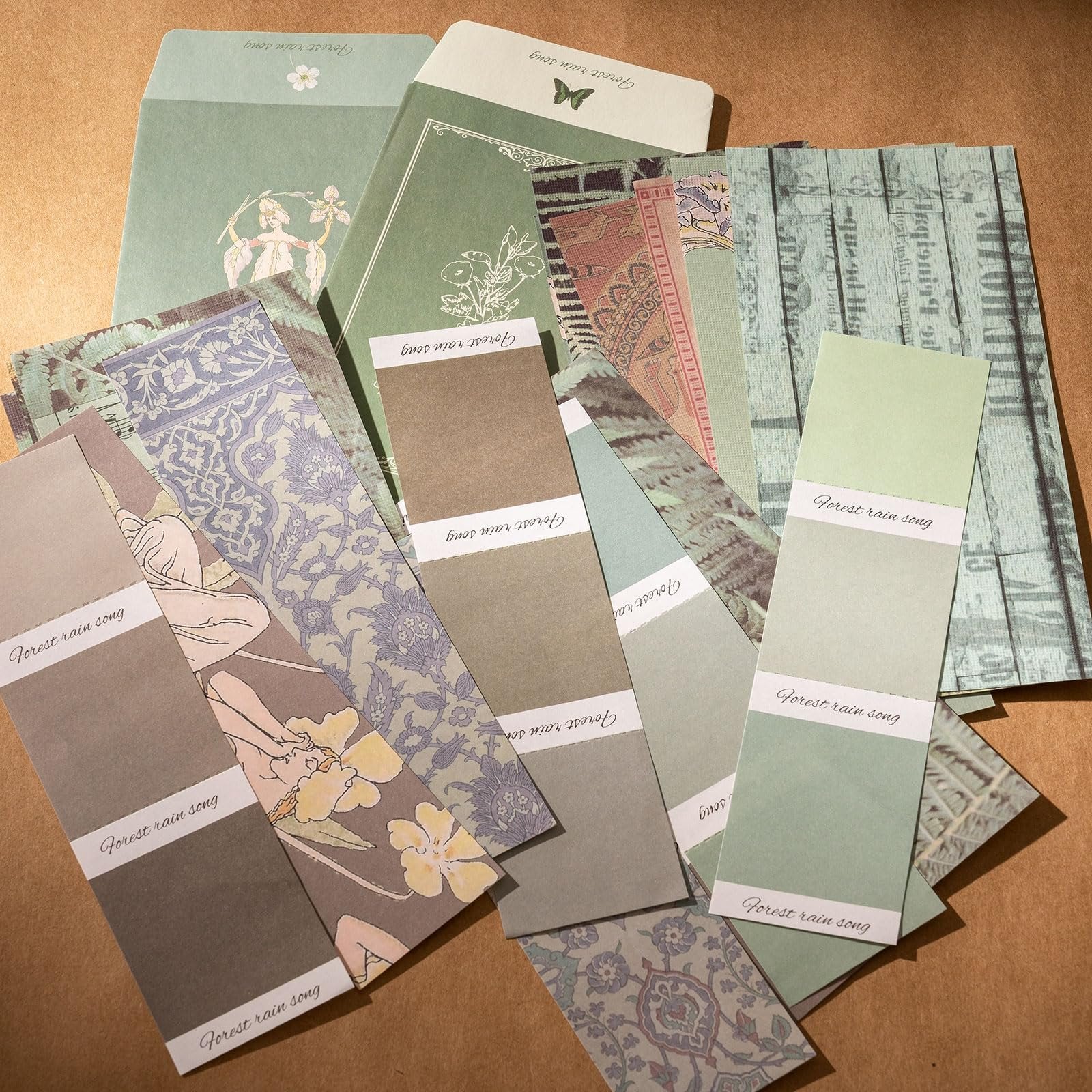 Scrapbook paper and envelopes with floral and vintage patterns, arranged in a flat lay.