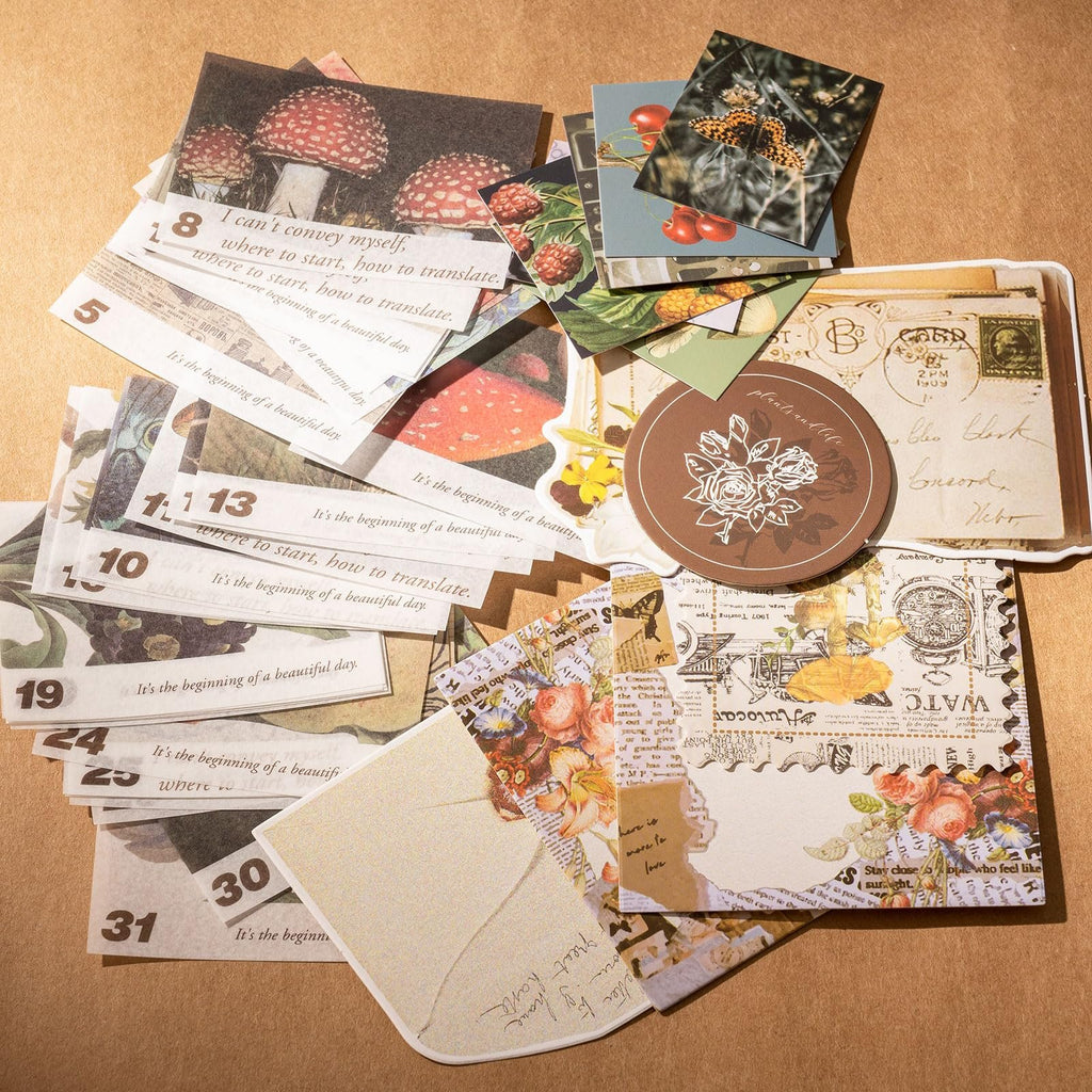 Scrapbook kit with various decorative papers featuring mushrooms, butterflies, flowers, and vintage text. Some papers have numbers and phrases.
