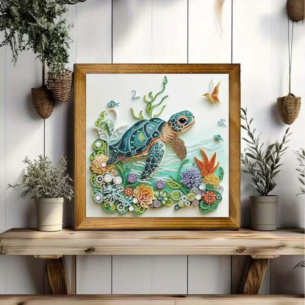 Sea turtle diamond painting kit displayed in a wooden frame on a shelf, featuring colorful rhinestones and underwater flora.