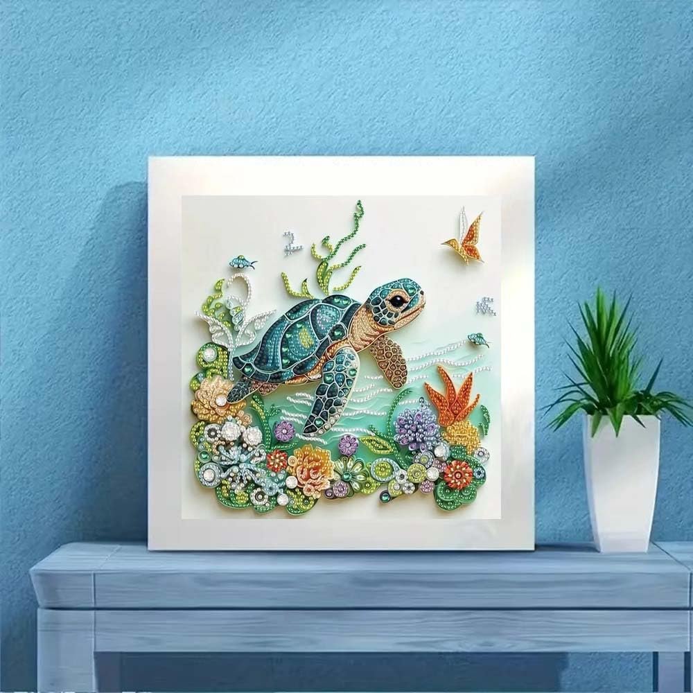 Sea turtle diamond painting kit with colorful coral and fish, displayed on a table.