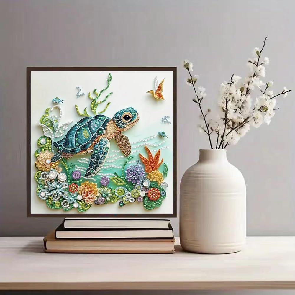 Sea turtle diamond painting kit artwork displayed on stacked books next to a vase of white flowers.