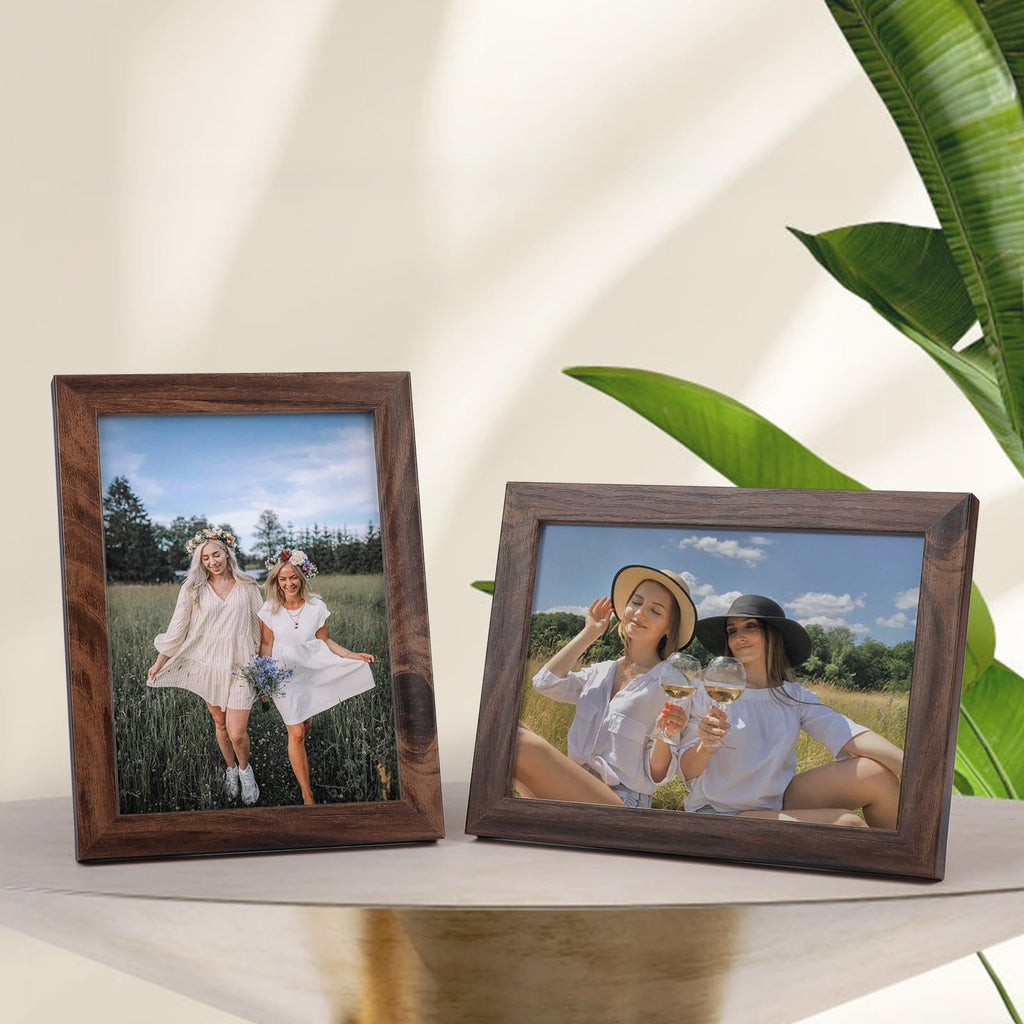 Two rustic brown wood picture frames displaying lifestyle photos of women in outdoor settings, on a table with a plant.