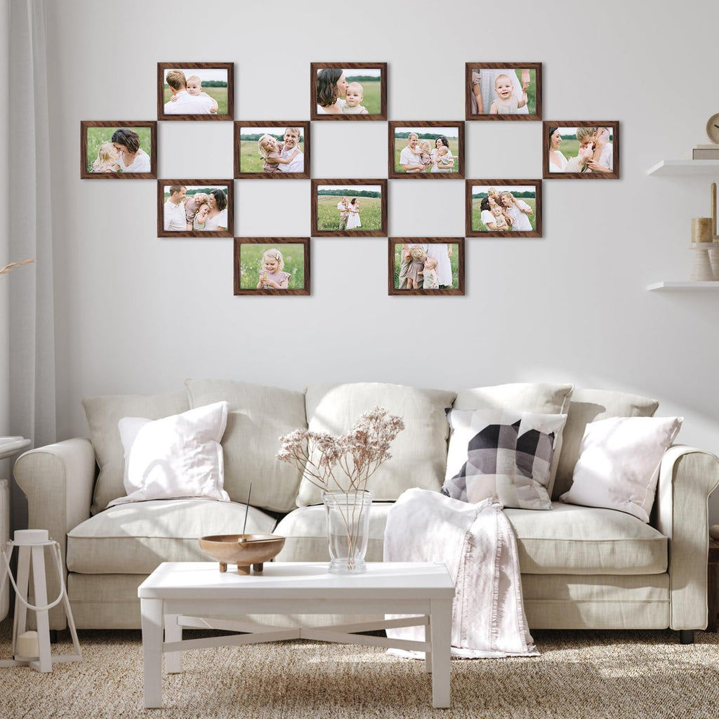 Living room scene with a wall display of 12 rustic brown 5x7 picture frames filled with family photos above a sofa and coffee table.