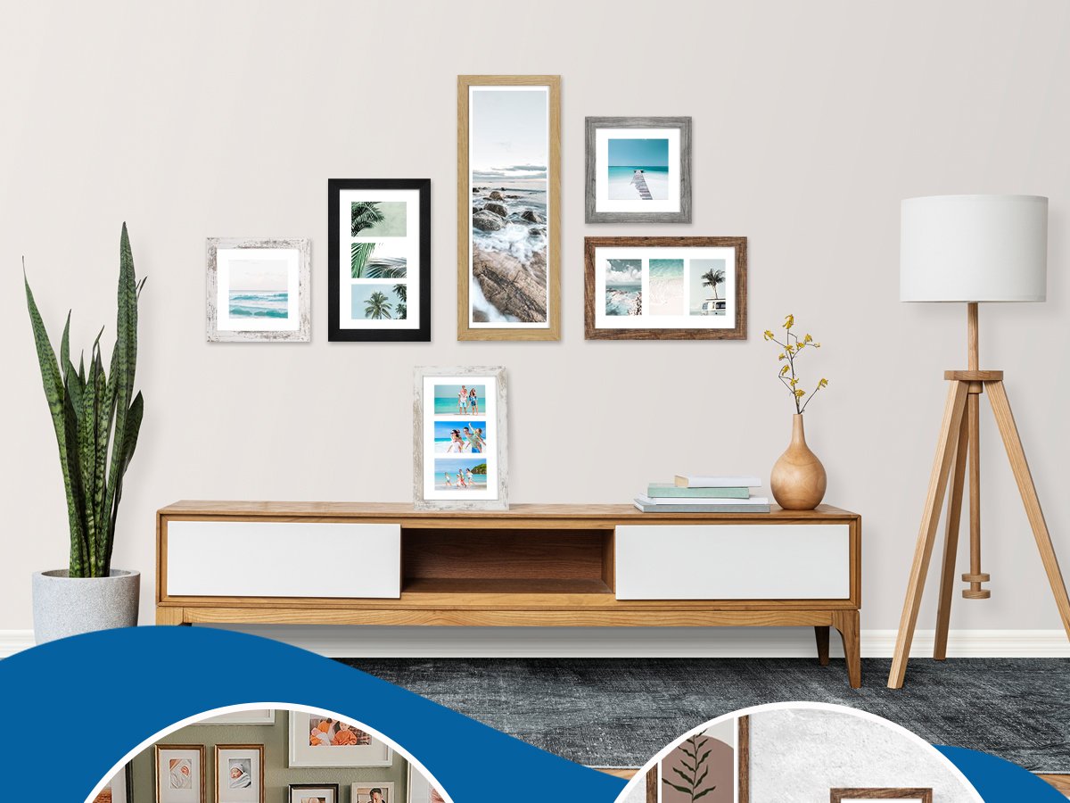 Gallery wall of distressed white wood picture frames and other frames displayed above a console table with a plant and lamp.
