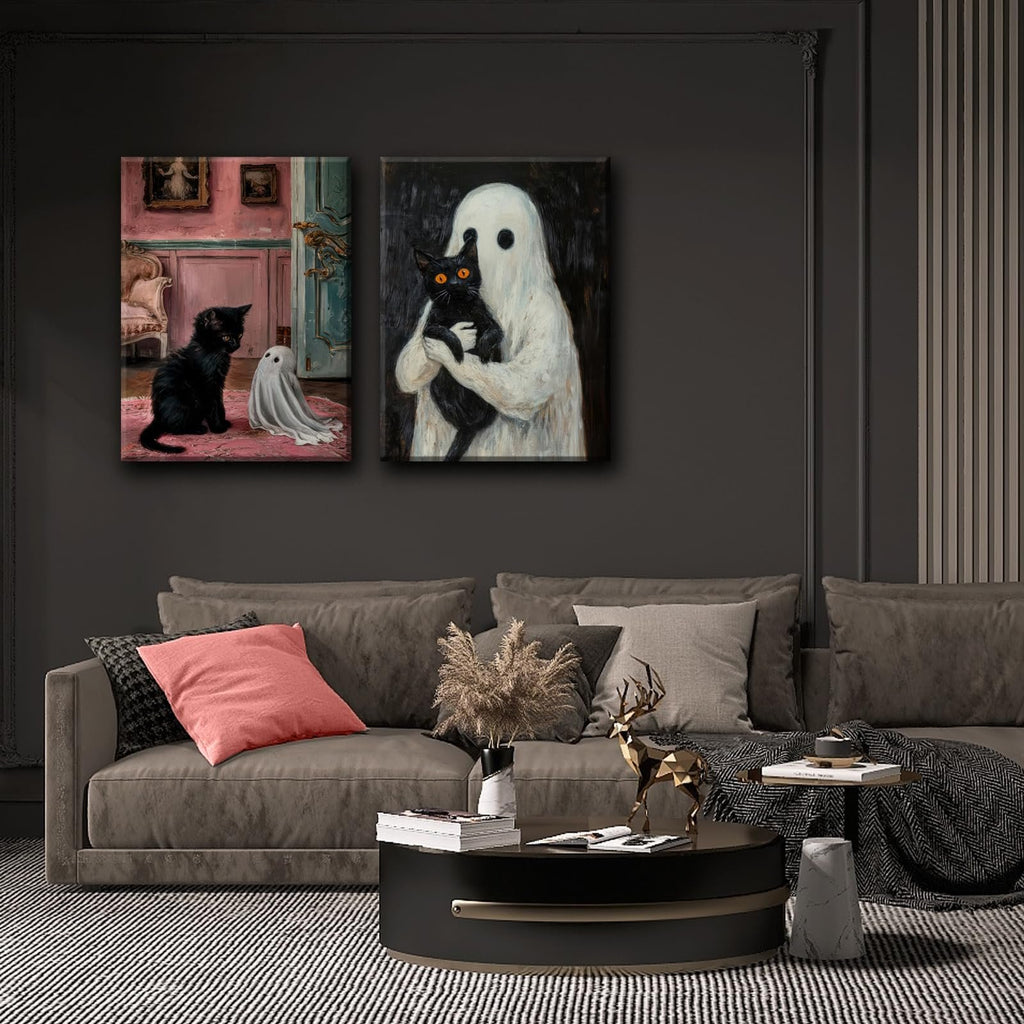 Two framed gothic Halloween canvas art prints of a black cat and a ghost displayed on a dark wall above a sofa.