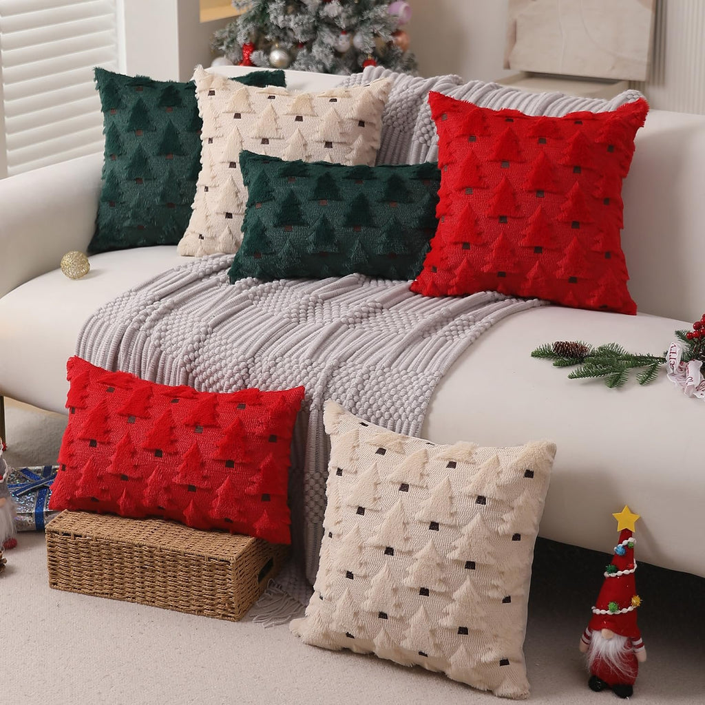 Set of six plush Christmas tree patterned pillow covers arranged on a sofa and floor, featuring red, green, and beige colors.