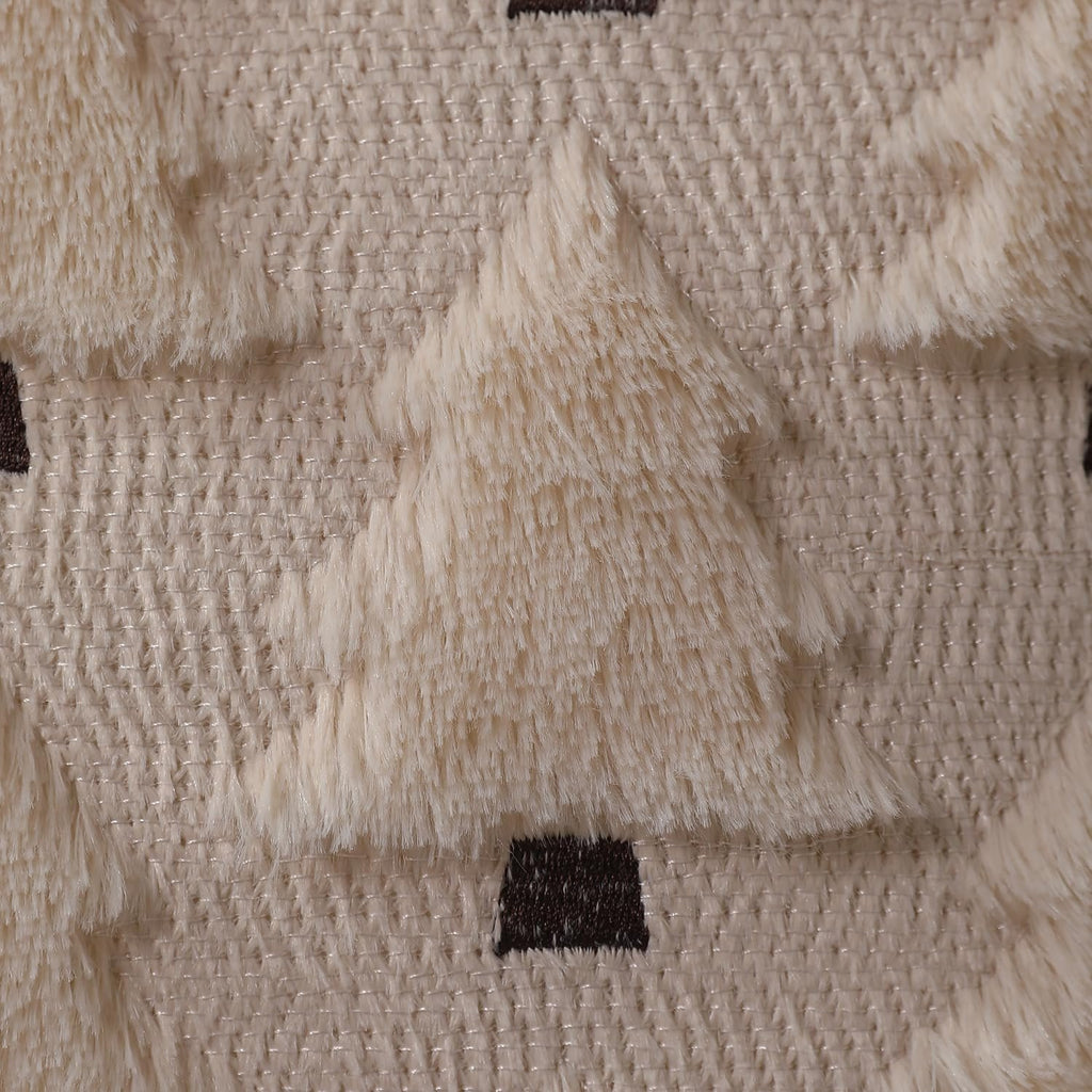 Close-up of a beige textured fabric with fluffy cream-colored Christmas trees and dark brown bases.
