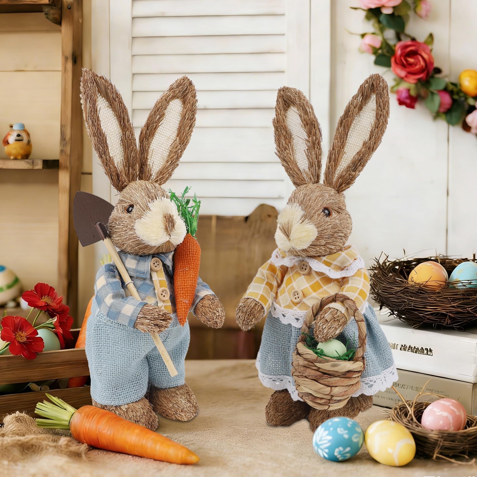 Two straw and sisal Easter bunny figurines, one holding a shovel and carrot, the other holding a basket with eggs.