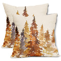 Two square pillow covers with a watercolor forest design in burnt orange and brown hues, shown at an angle.
