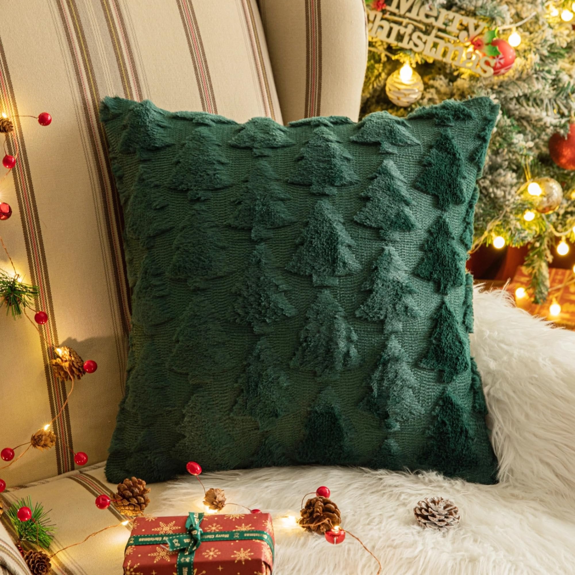 Green Christmas throw pillow cover with textured trees, on a chair with festive decorations.