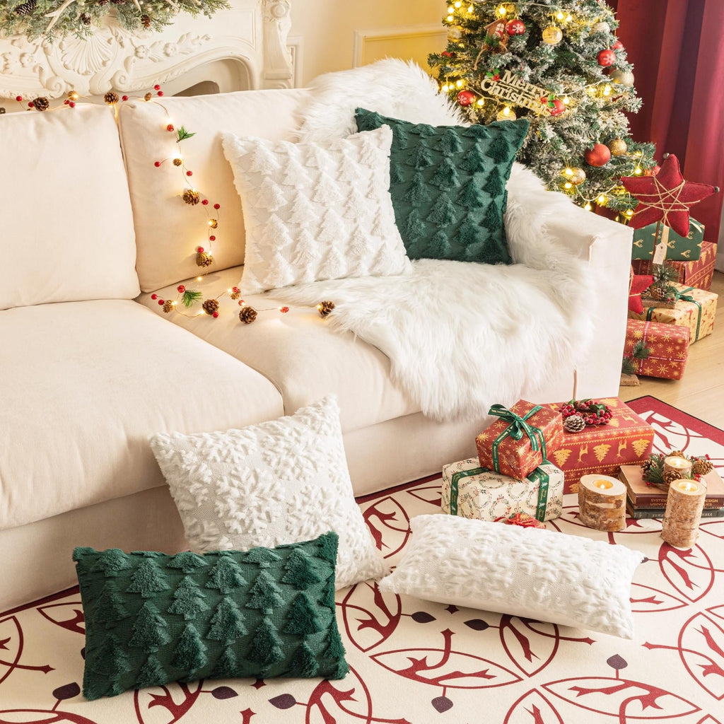 Christmas throw pillows and festive decor arranged on a couch and floor.