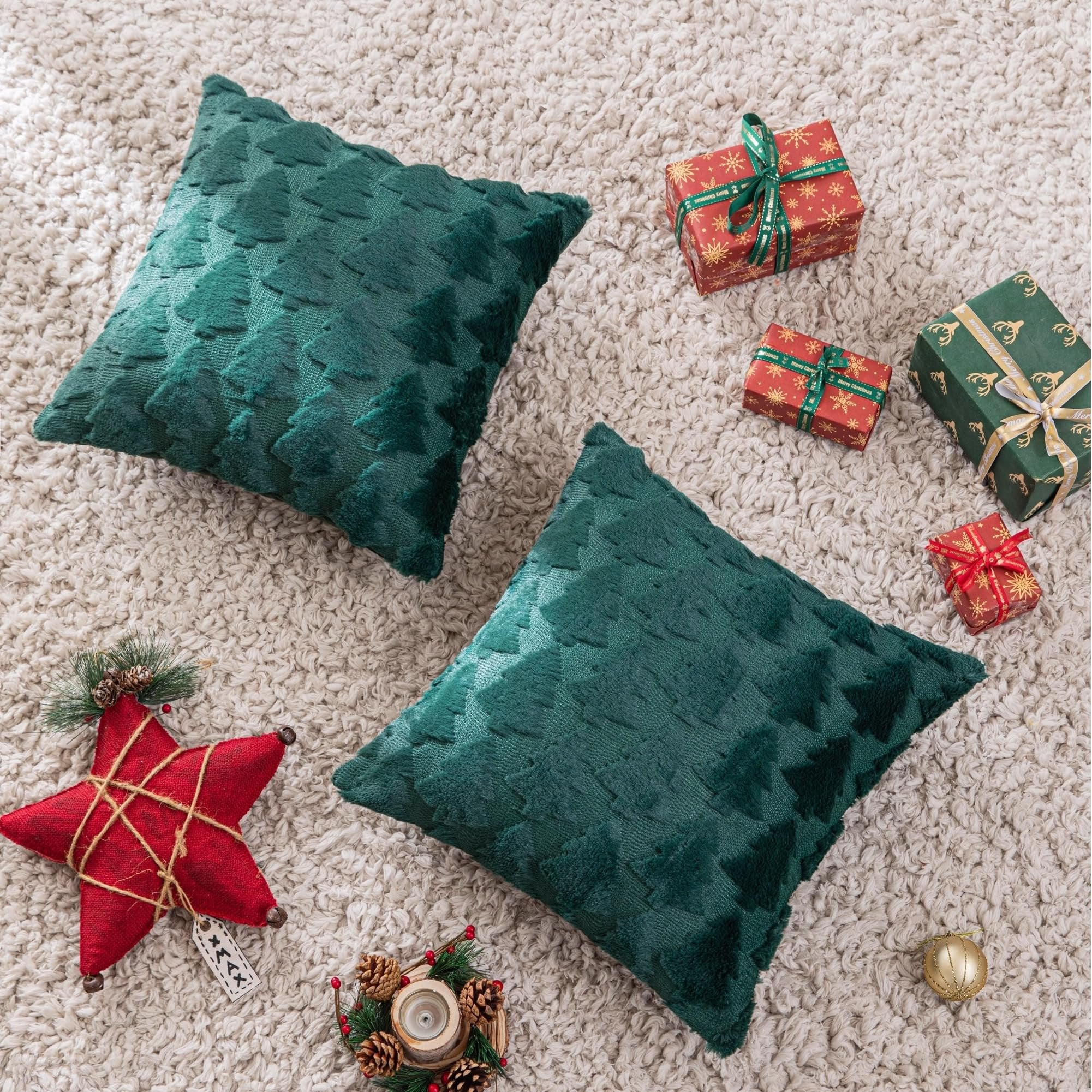 Two green Christmas throw pillow covers with tree pattern on a fluffy rug, surrounded by gift boxes and holiday decor.