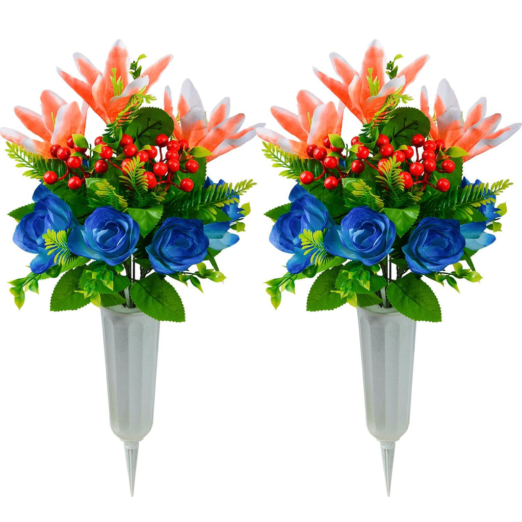 Two artificial cemetery flower bouquets with orange lilies, blue roses, and red berries in plastic vases with ground spikes.