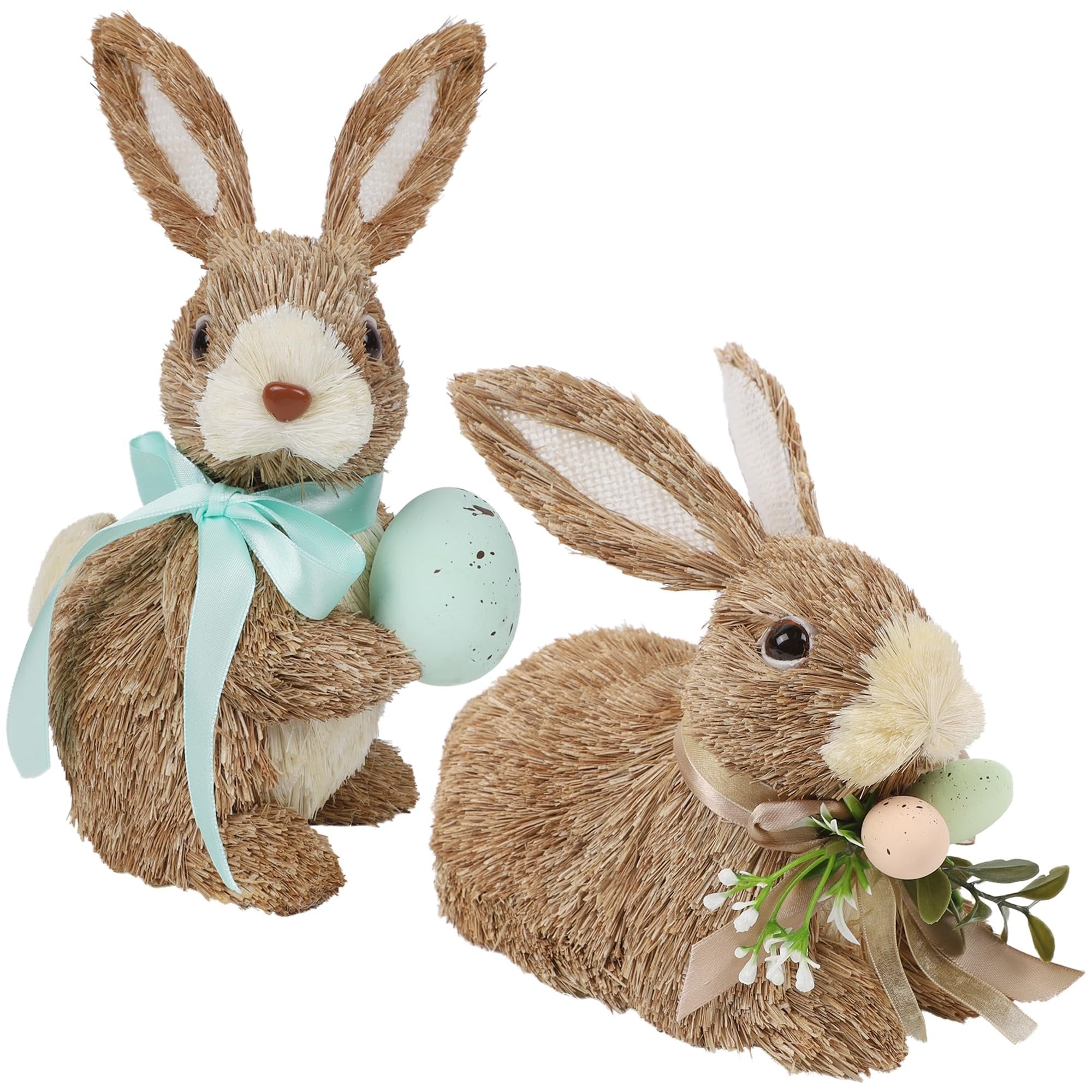 Two sisal bunny figurines, one holding an egg and wearing a blue ribbon, the other adorned with eggs and greenery.