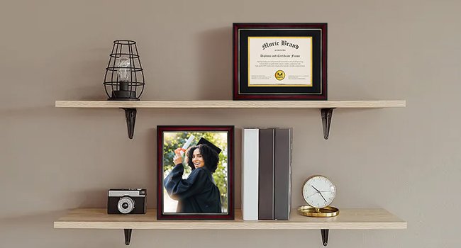 Two diploma frames displayed on shelves with a graduation photo and decorative items.